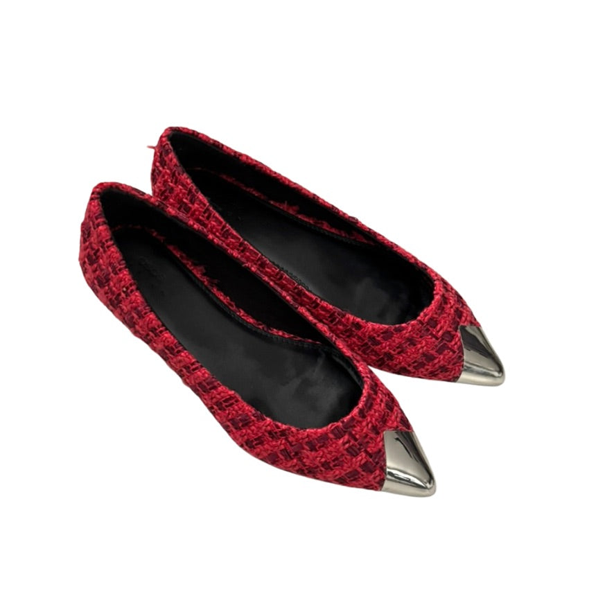 Red pointed-toe flats with metallic tips on a white background