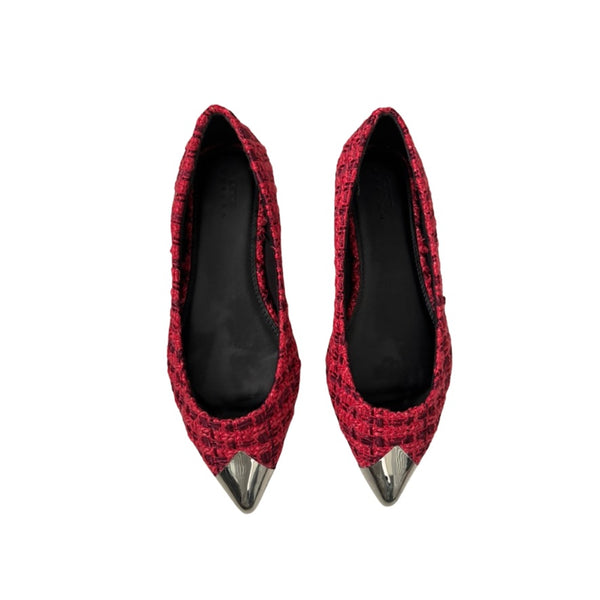 Red pointed-toe shoes with metallic tips on a white background