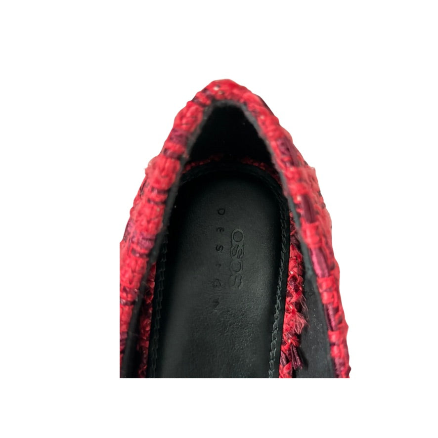 Red and black patterned shoe with a visible brand logo on a white background