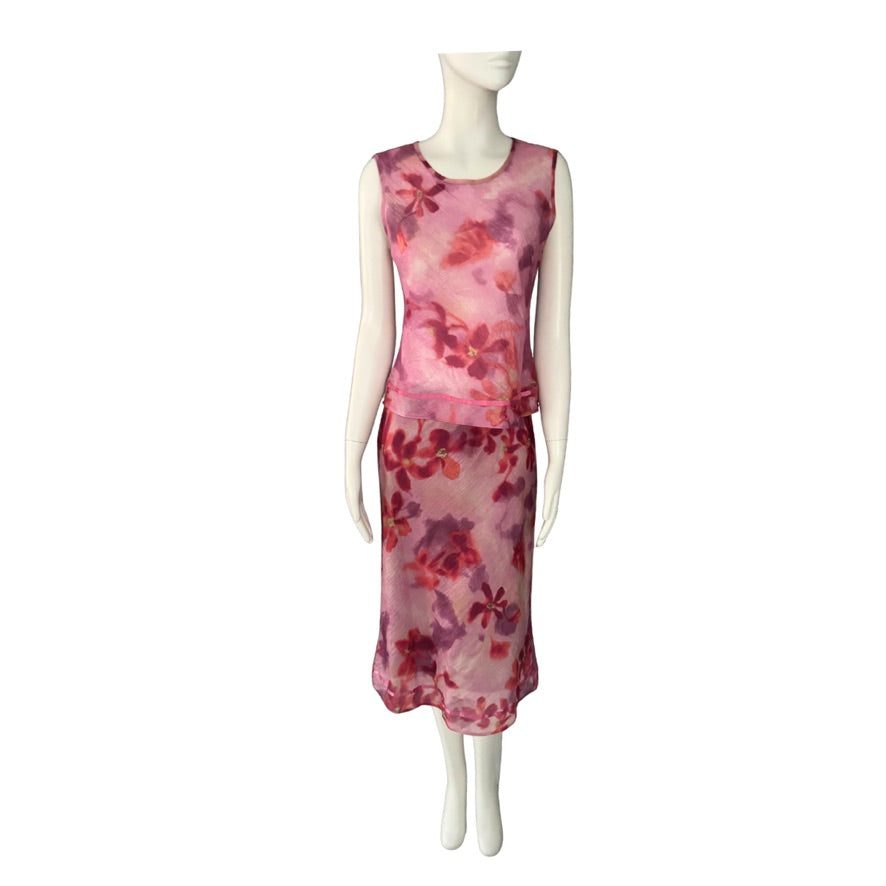 Mannequin wearing a pink floral top and skirt  on a white background
