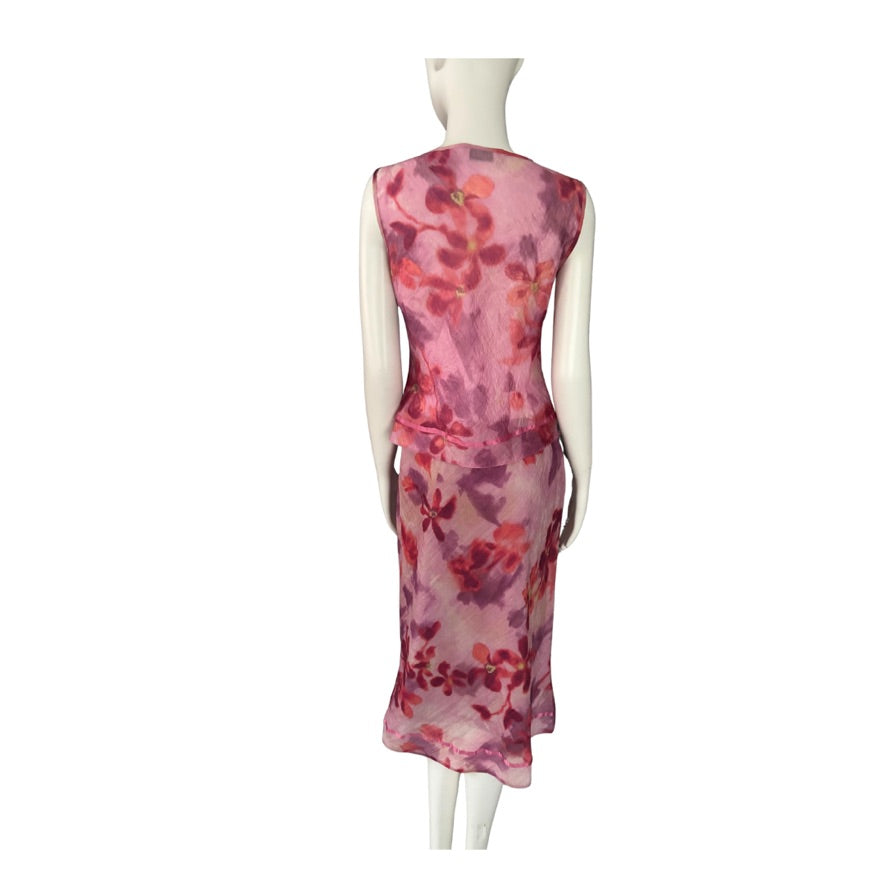 Mannequin wearing a pink floral top and skirt on a white background