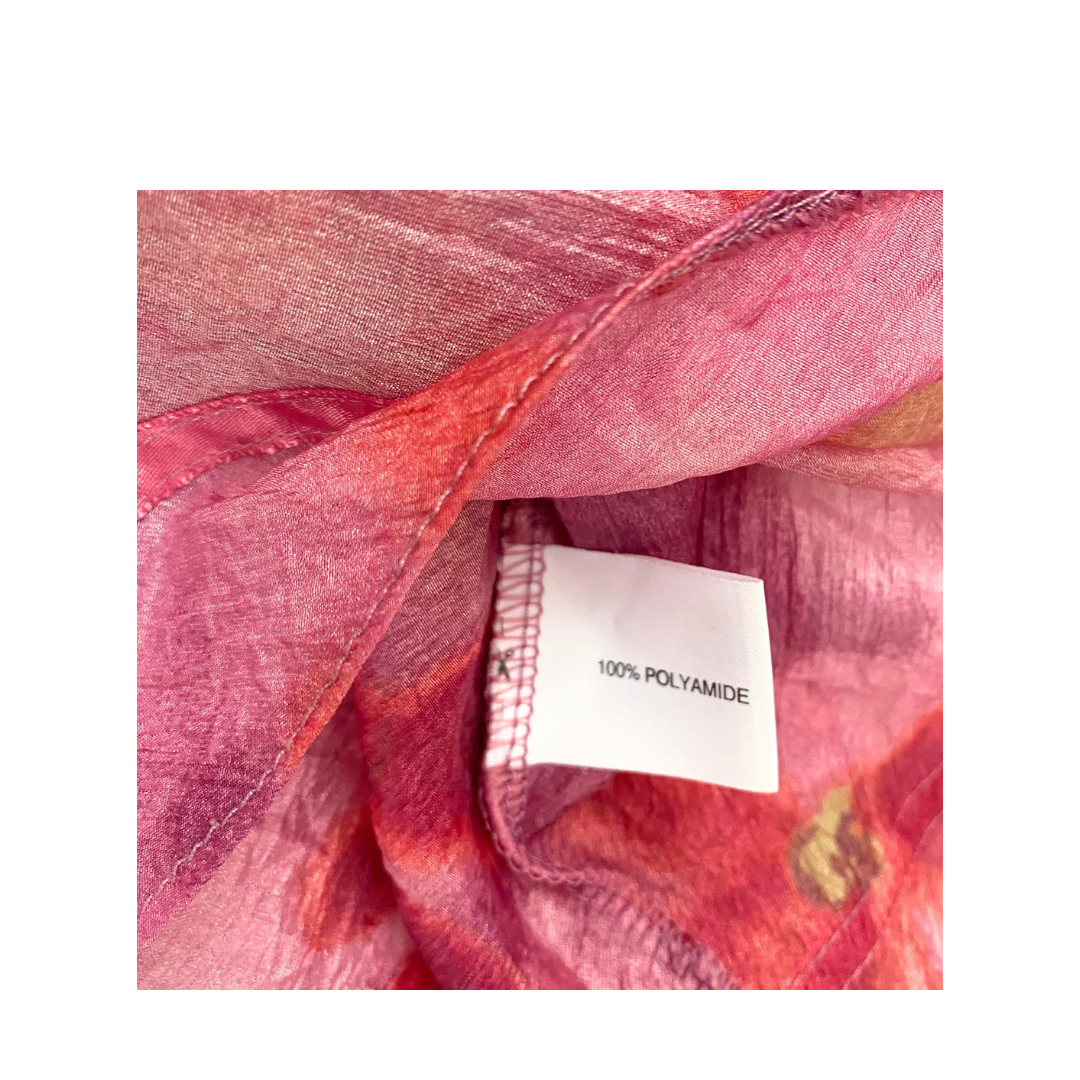 Close-up of pink fabric with a '100% Polyamide' label.