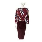 Mannequin wearing a burgundy multicolored pattern top and burgundy skirt with on a white background