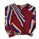 Colorful patterned top on a white background