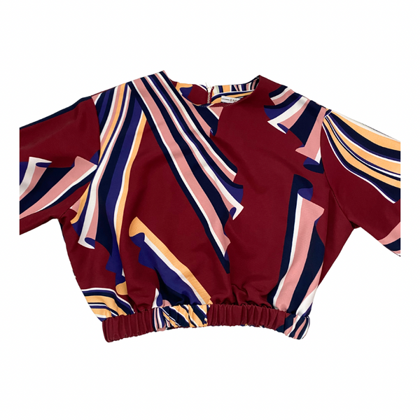 Colorful patterned top on a white background