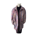 Mannequin wearing a patterned coat on a white background