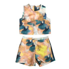 A sleeveless crop top and tailored shorts with an abstract multicolored print, predominantly in shades of peach, teal, and yellow.