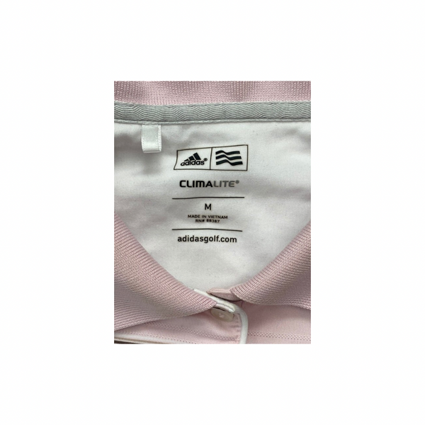 Close-up of Adidas Climalite label on a garment with pink and gray fabric.