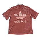 Pink Adidas t-shirt with white logo on a white background
