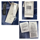 Close-up of Adidas clothing tags with brand logo and text on a blue fabric background