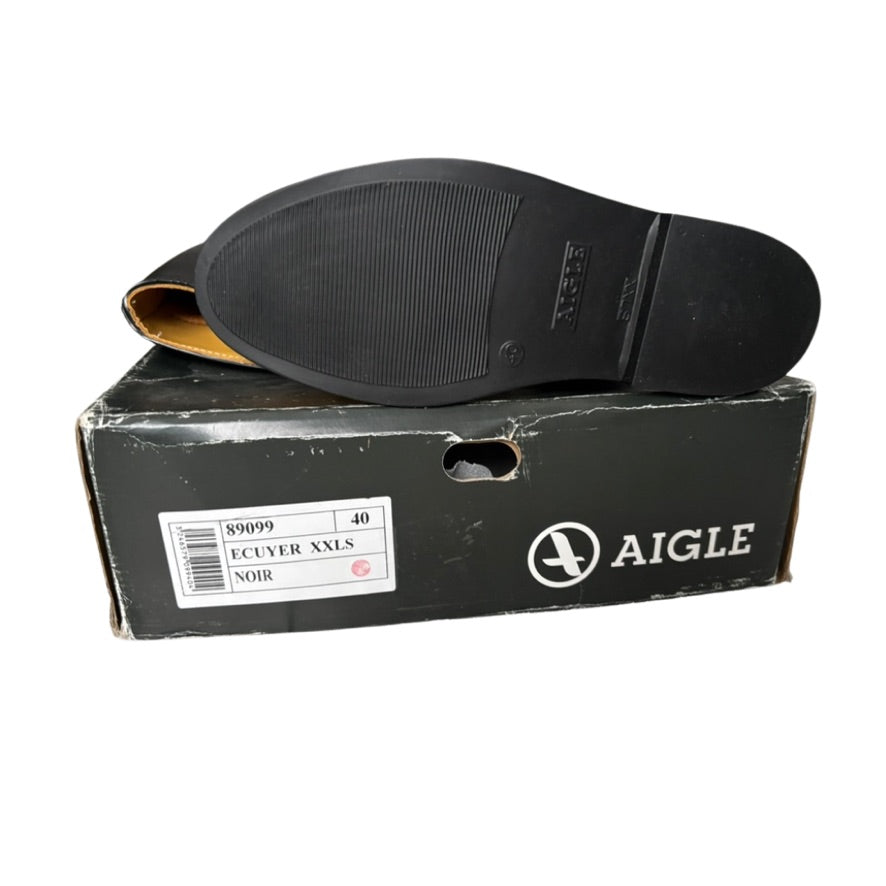 Black shoe sole on a black Aigle shoe box with white text