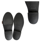 Black rubber sole of a boot with 'Aigle' branding on a white background