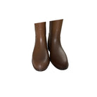 Pair of brown rubber boots on a white background