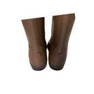Pair of brown rubber boots on a white background