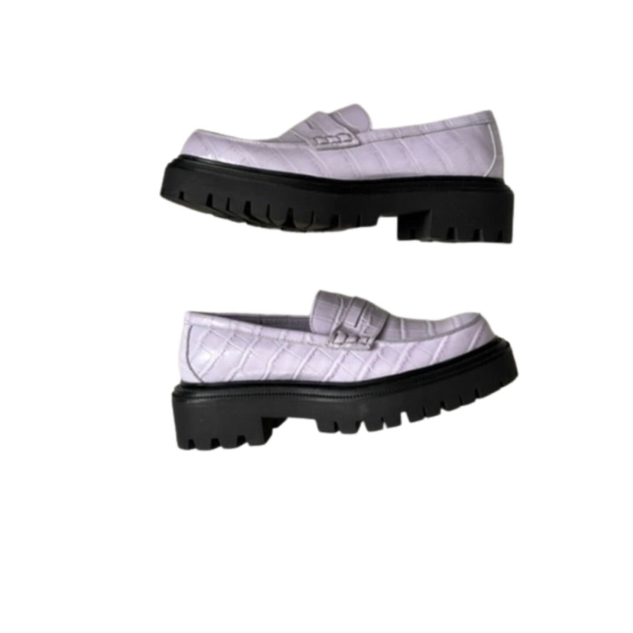 Pair of lilac loafers with black soles on a white background