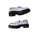 Lilac loafers with black soles on a white background