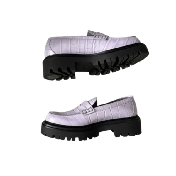 Lilac loafers with black soles on a white background