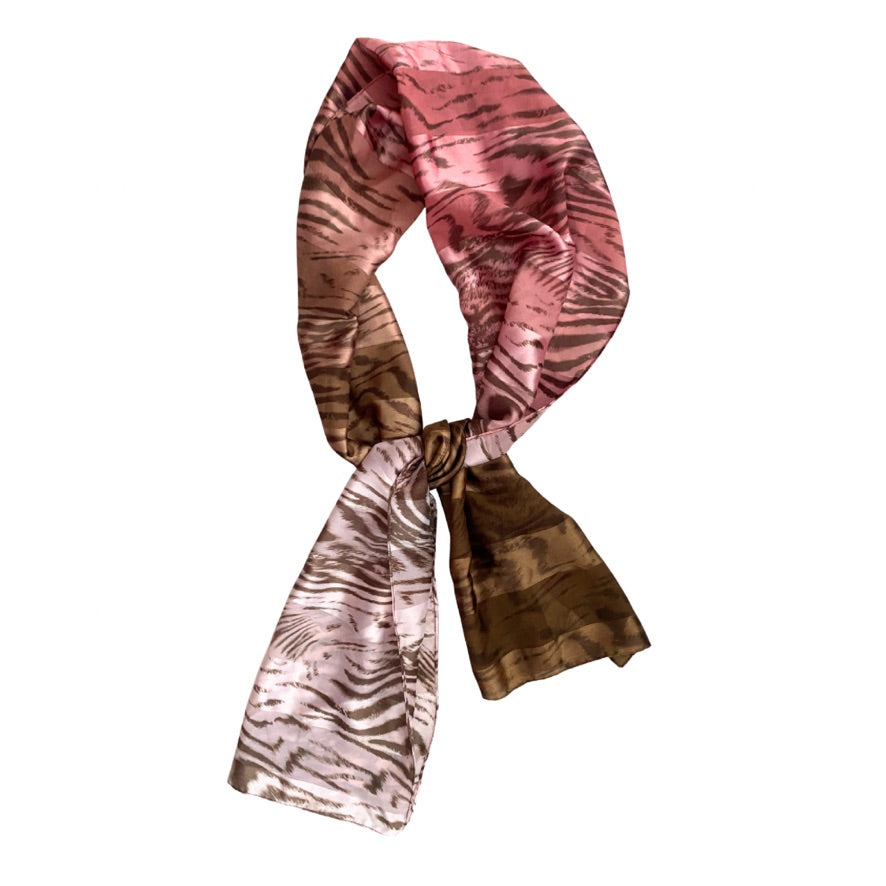 Pink and brown patterned scarf on a white background