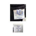 Close-up of a clothing label with 'Aqua' branding and 'Made in England' text.