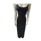 Black dress on a mannequin against a white background