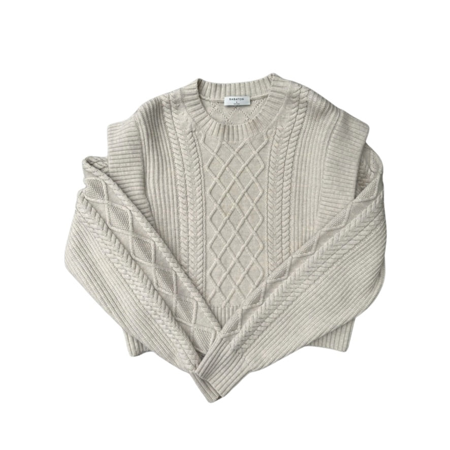 Beige cable knit sweater on a white background