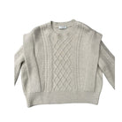 Beige cable knit sweater on a white background