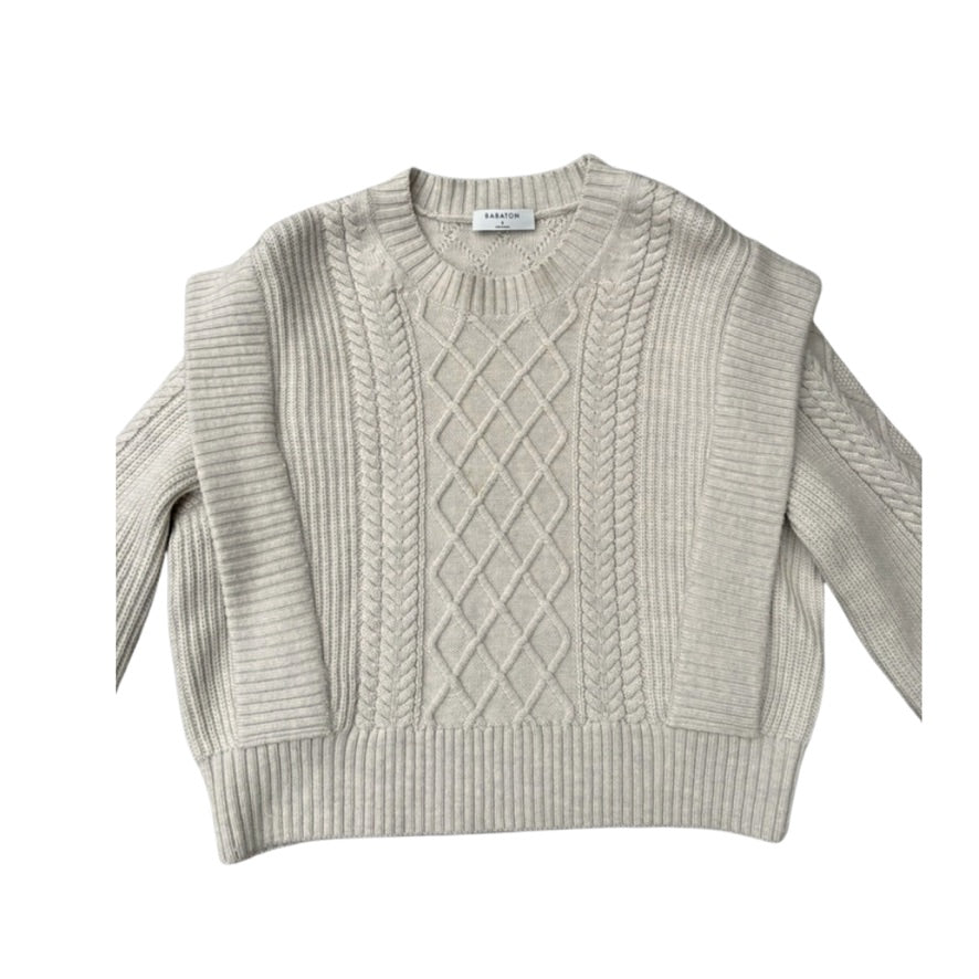 Beige cable knit sweater on a white background