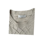 Folded gray sweater with 'Babaton' label on a white background