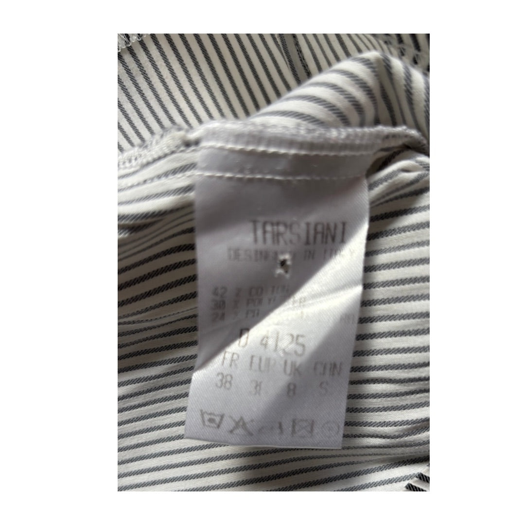 Close-up of a striped shirt with a visible label on a white background