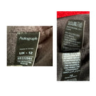 Clothing labels with 'Autograph' and other text on a fabric background