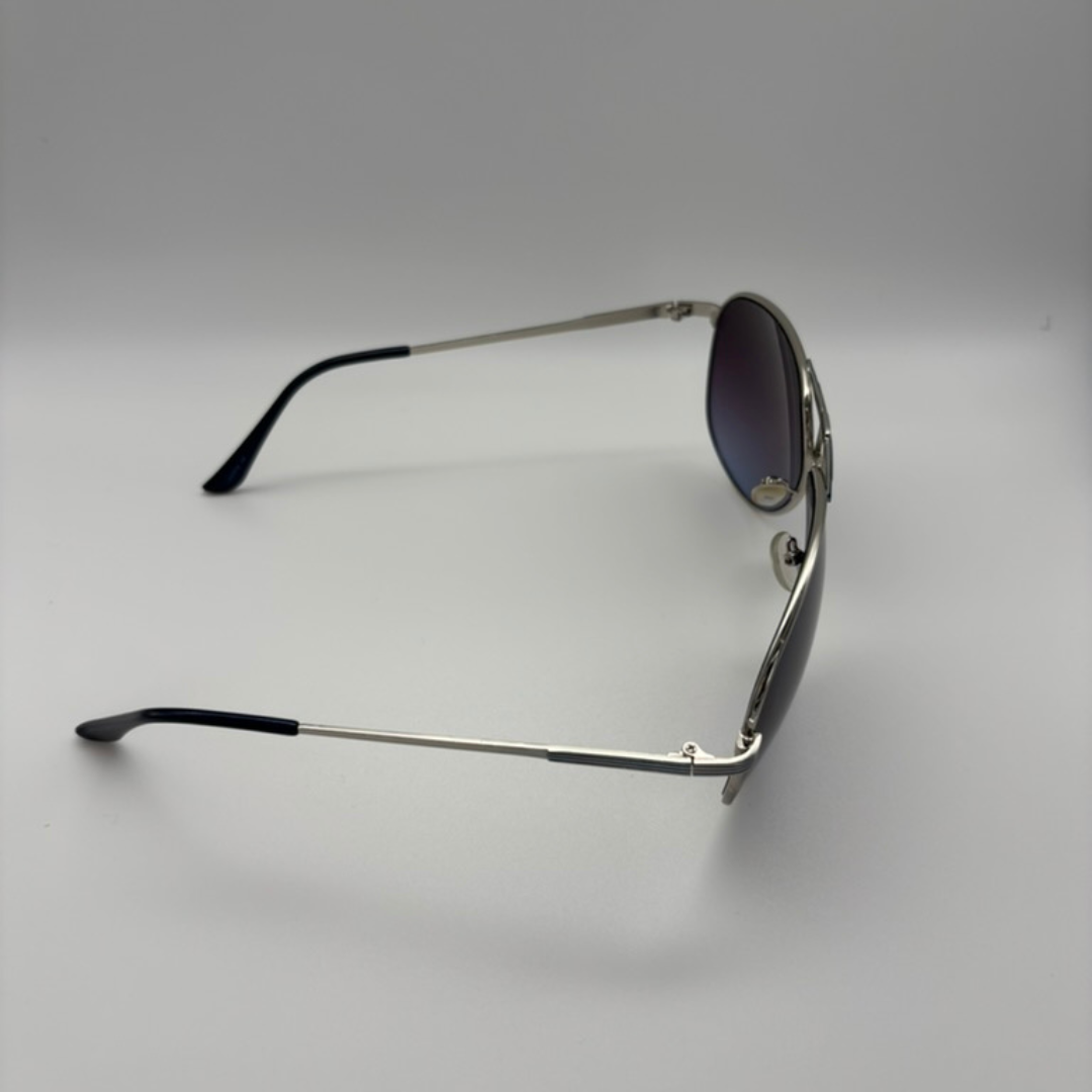 Sunglasses with metal frame and dark lenses on a light gray background