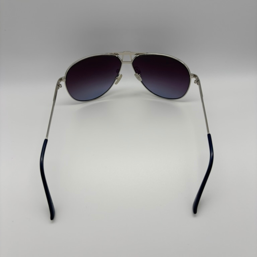 Aviator sunglasses with dark lenses on a light gray background
