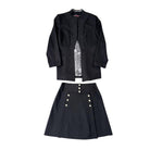 Black outfit with jacket and skirt on a white background