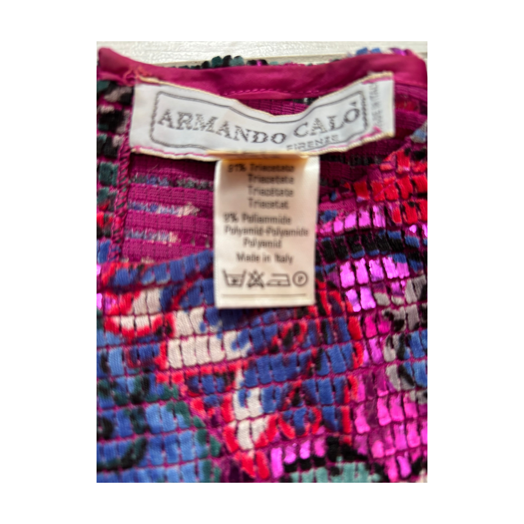 Close-up of a colorful fabric with an Armando Calgi label on a white background