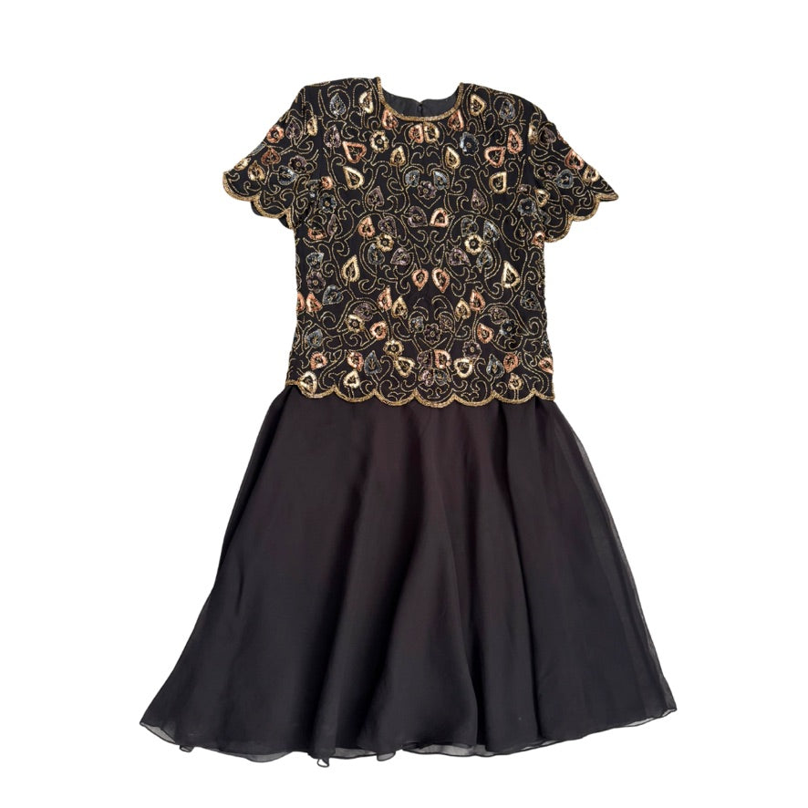 Black dress with gold lace top on a white background