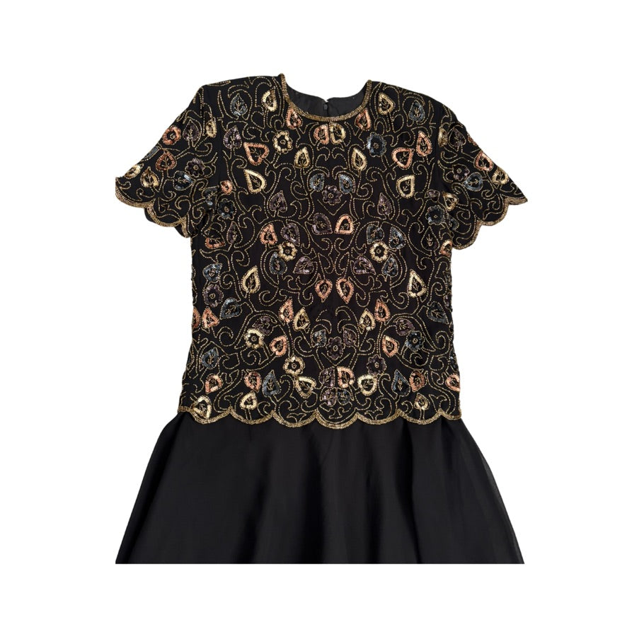 Black dress with intricate gold embroidery on a white background