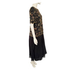 Mannequin wearing a black dress with a patterned top on a white background