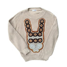 Beige sweater with decorative front panel on a white background