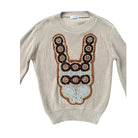 Beige sweater with decorative brown and white pattern on a white background