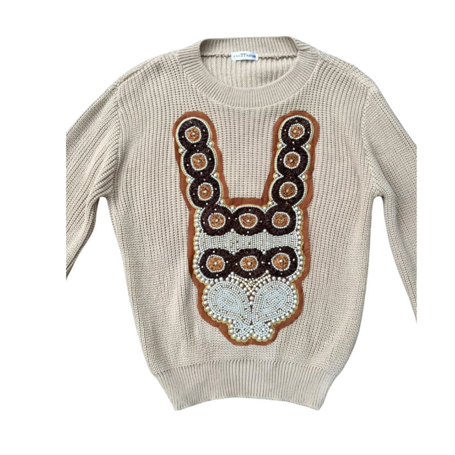 Beige sweater with decorative brown and white pattern on a white background