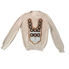 Beige sweater with a decorative front design on a white background