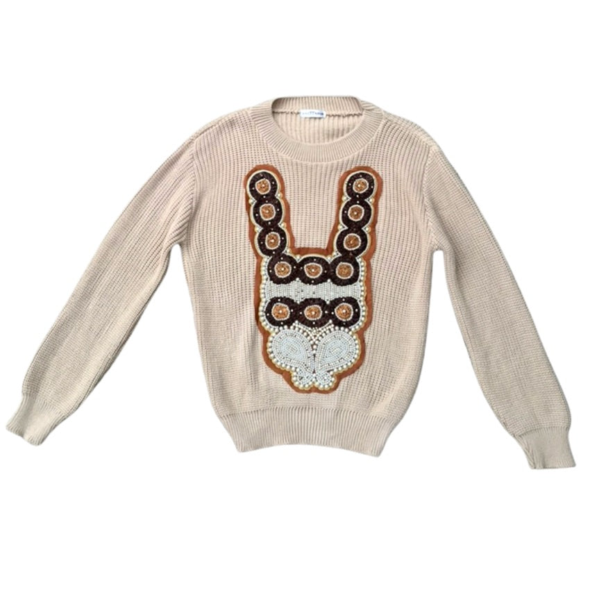 Beige sweater with a decorative front design on a white background