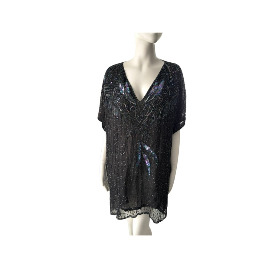 Black sequin top on a mannequin against a white background