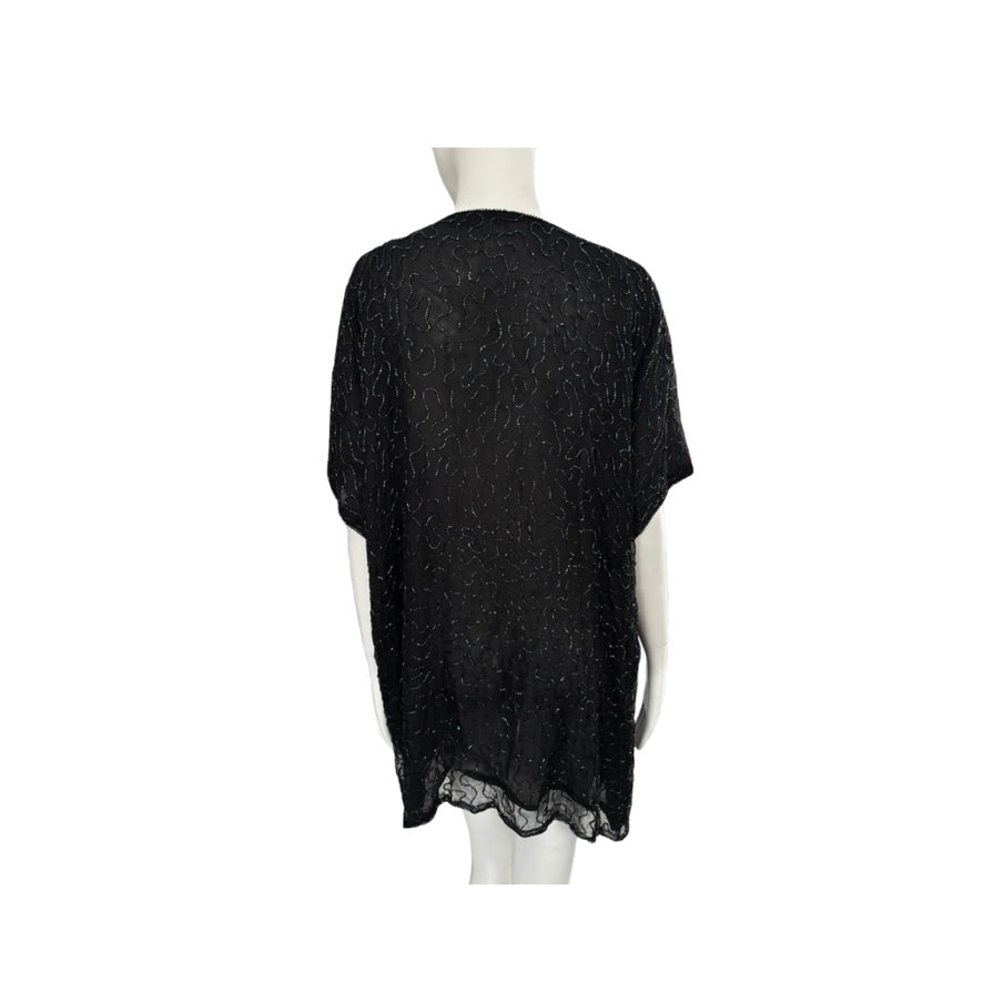 Black lace-trimmed top on a mannequin against a white background