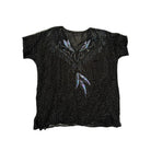 Black t-shirt with decorative patterns on a white background