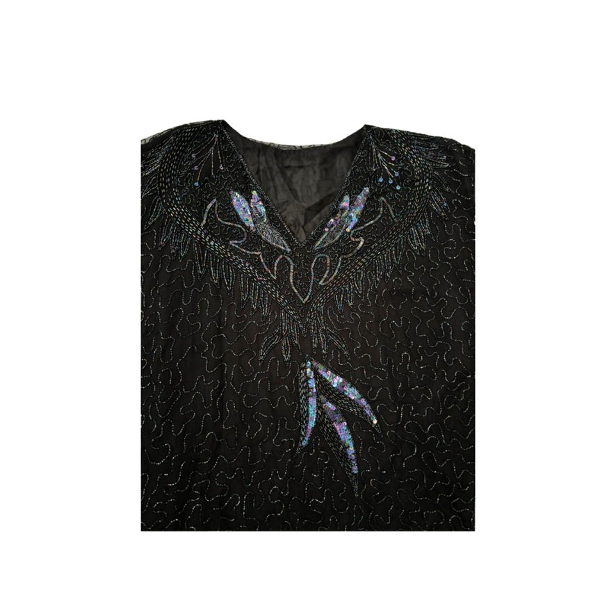 Black dress with feather-like bead embellishments on a white background