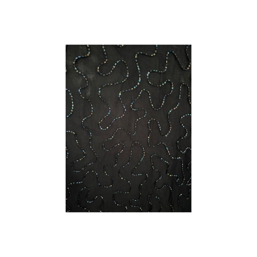 Black fabric with wavy white stitching pattern on a white background