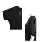 Black beaded top on a mannequin with close-up details on a white background