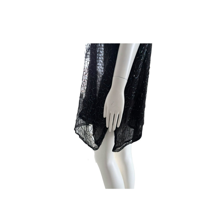 Black lace garment on a mannequin against a white background