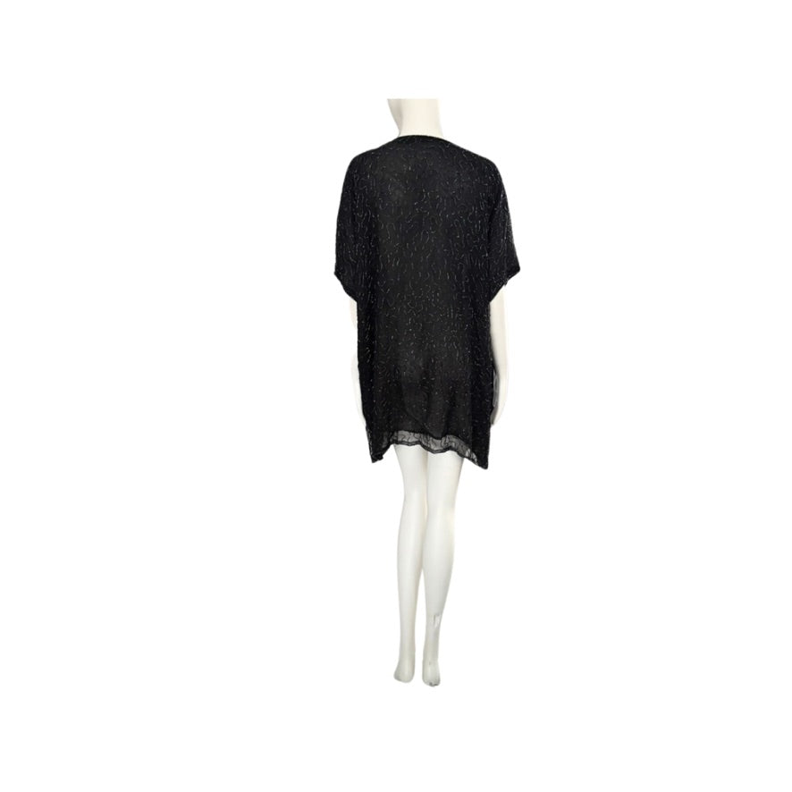 Black dress on a mannequin against a white background